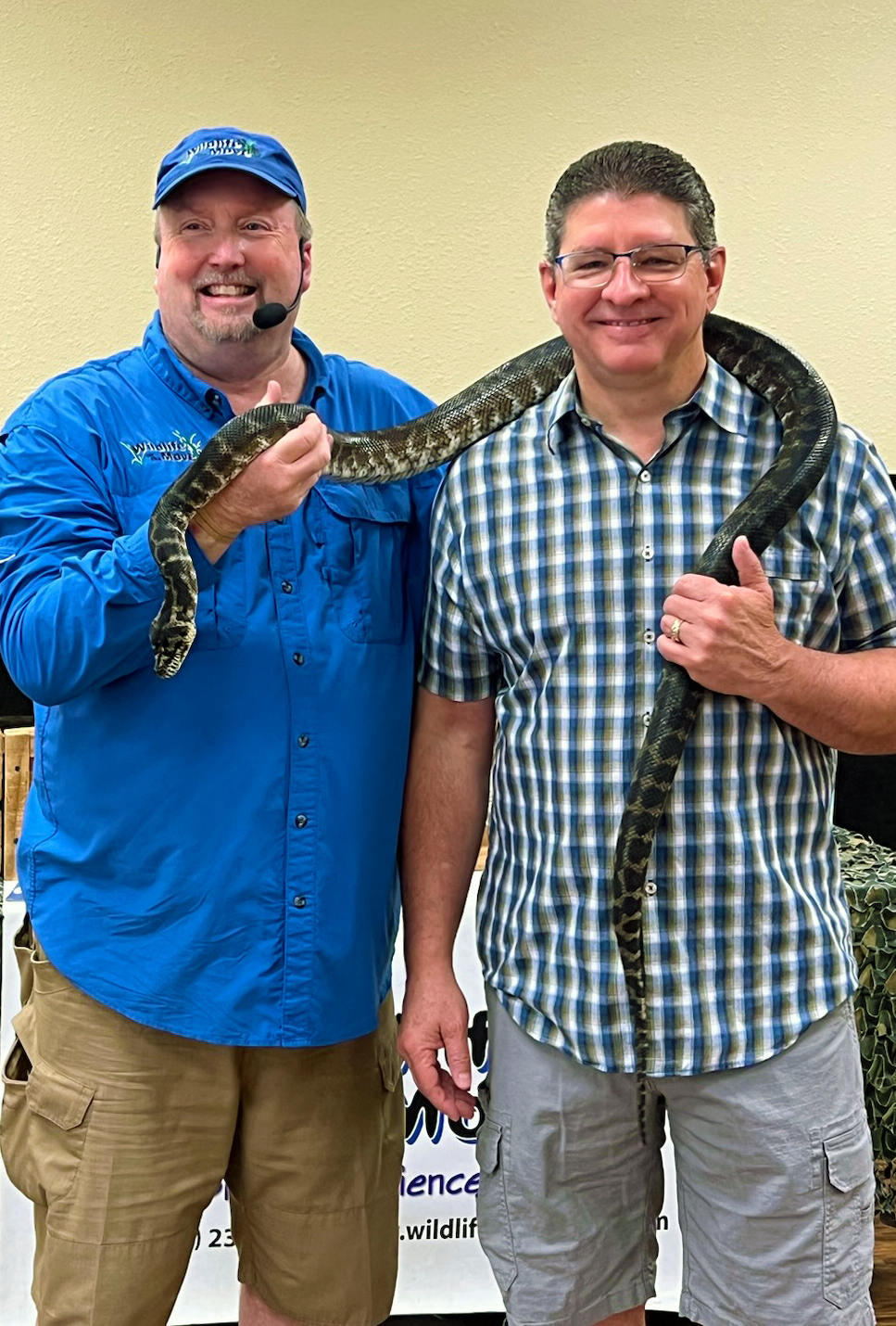 Presenter and man with snake around his neck